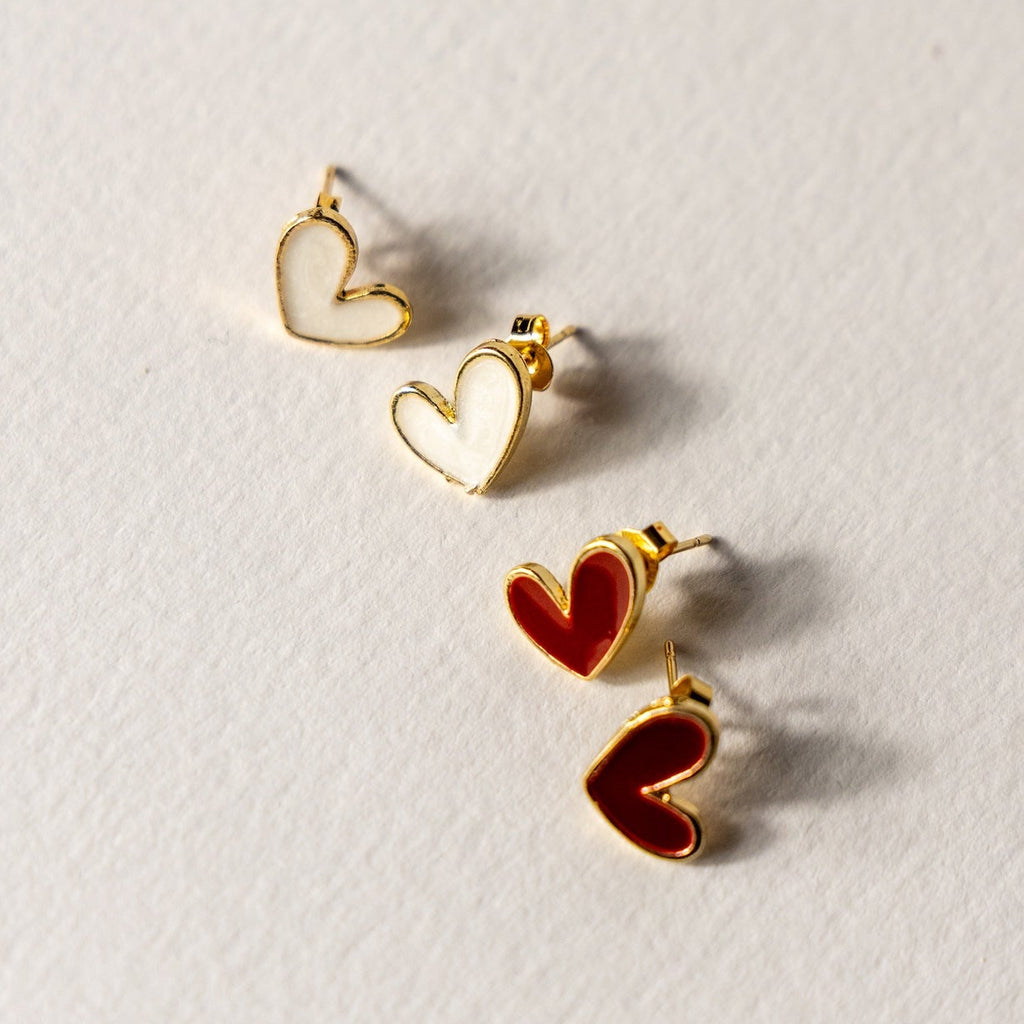 Heart-shaped earrings on a light gray background