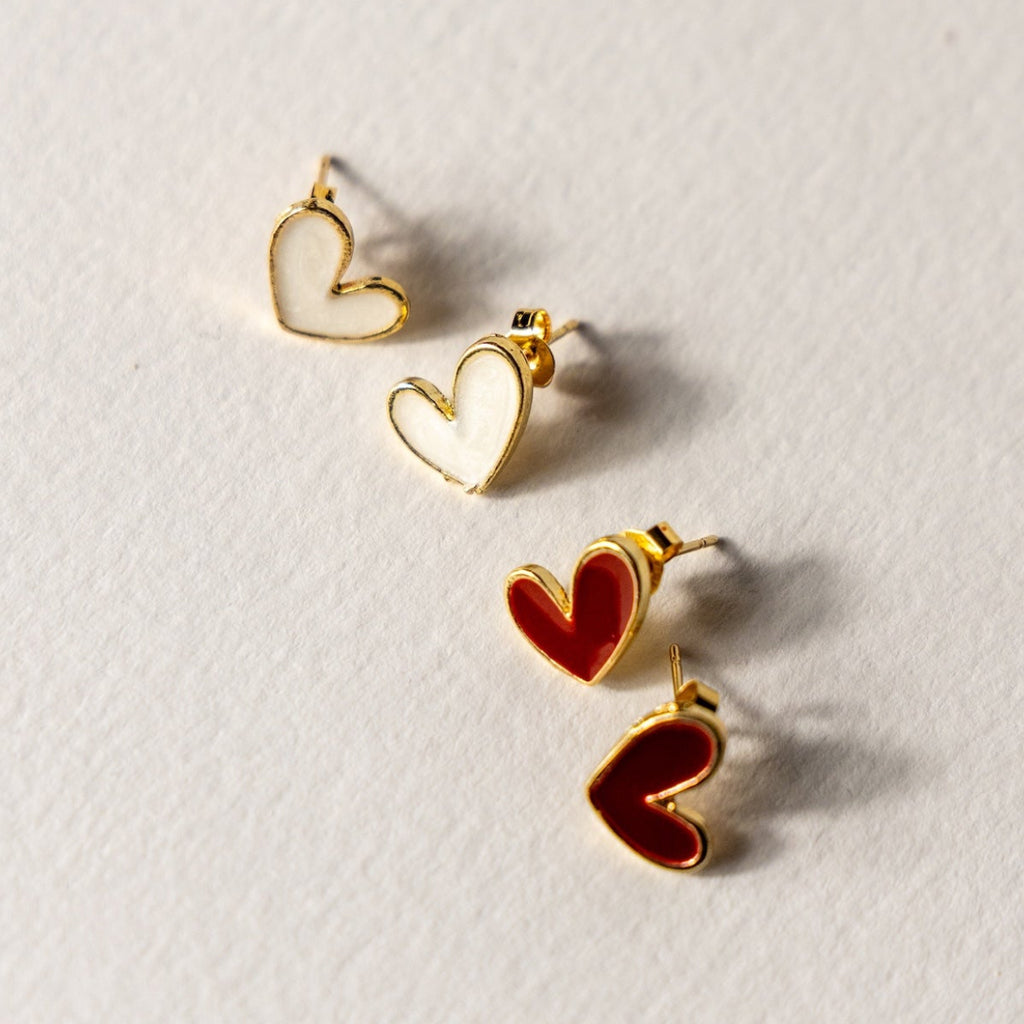 Heart-shaped earrings on a light gray background