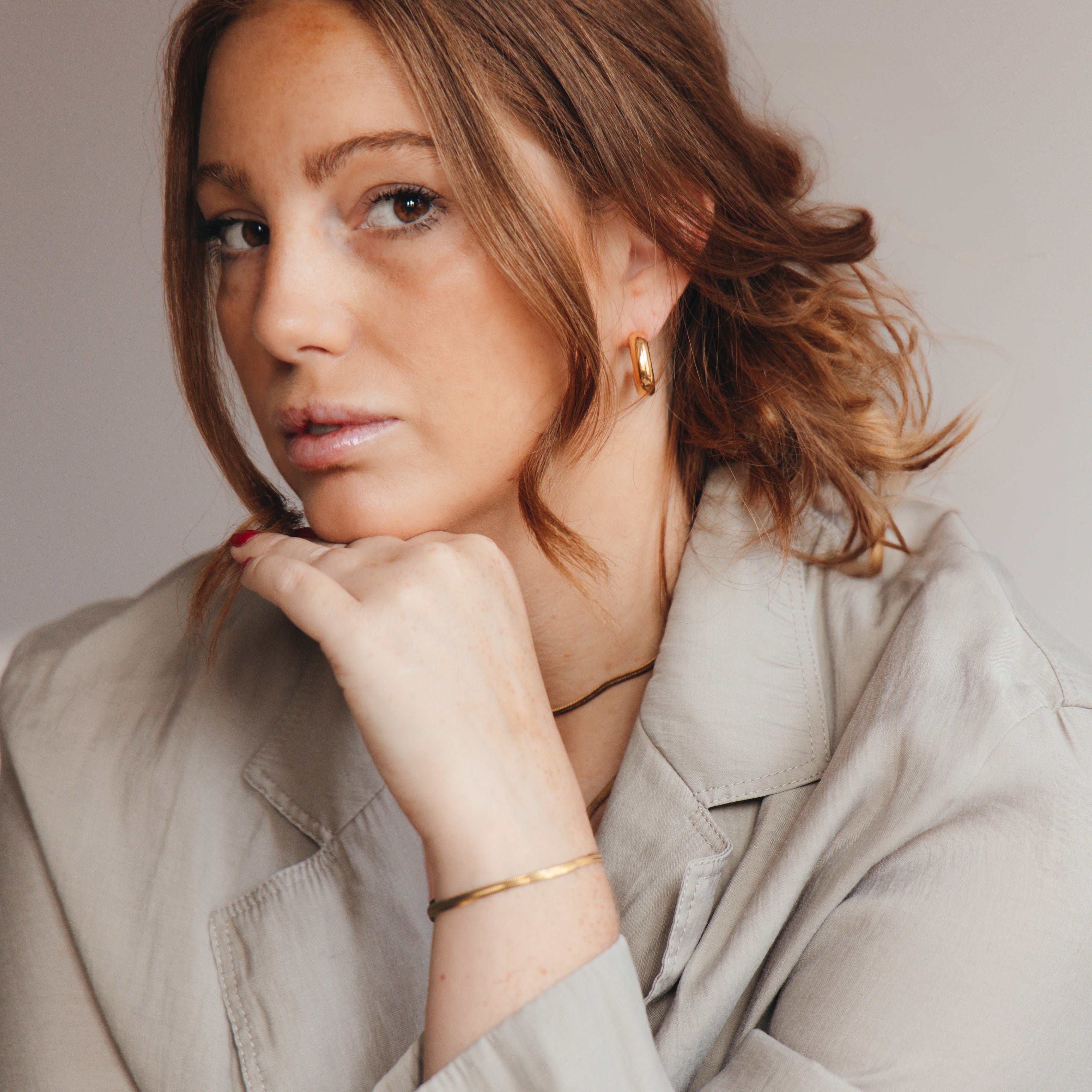 Woman wearing understated gold bracelet 