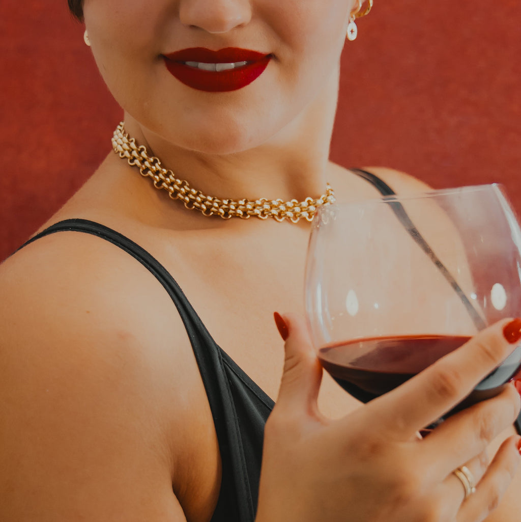 Woman holding a glass of red wine with a blurred background