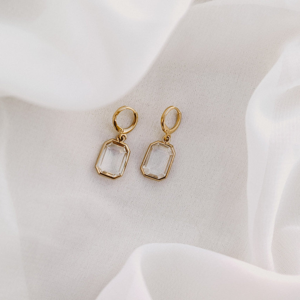 Allana faceted drop huggie earrings on white silk
