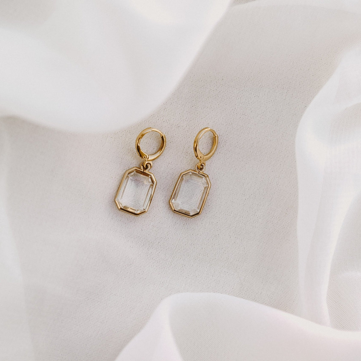 Allana faceted drop huggie earrings on white silk