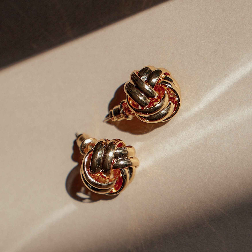 Beatrice gold knot stud earrings in soft shadow