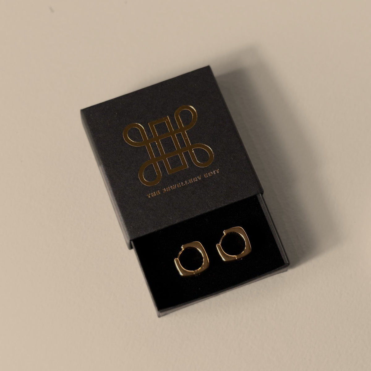 Emily square hoop earrings in a The Jewellery Edit gift box, from above