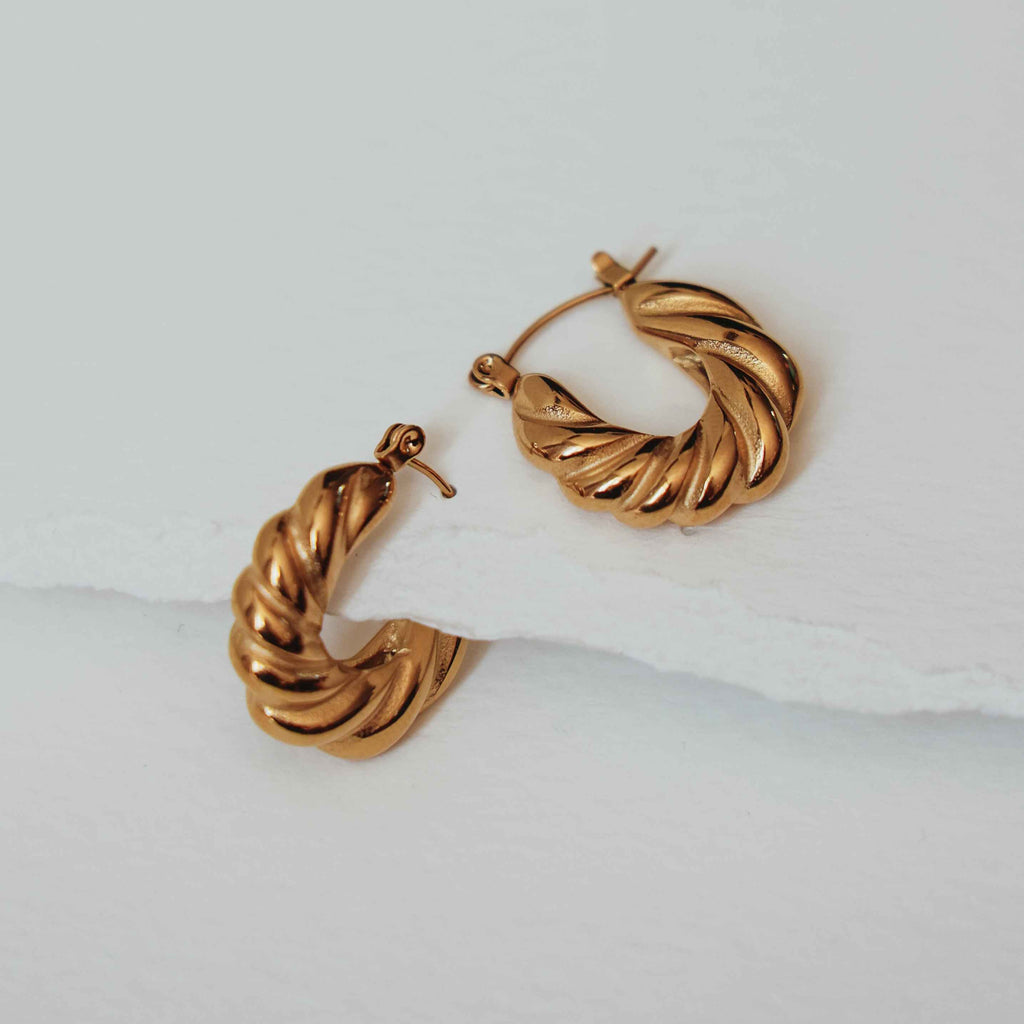 Katherine plaited gold hoop earrings on a light background